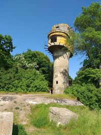 Low angle view of tower against clear blue sky