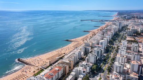 High angle view of sea and buildings against sky