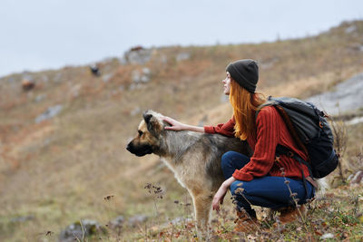 Woman on field against mountain