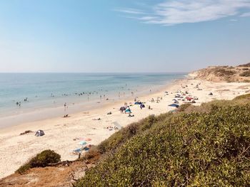 People on beach against sky