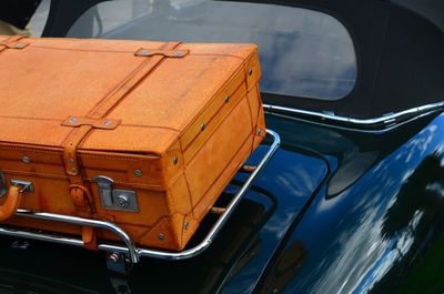 High angle view of suitcase over car