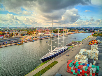 High angle view of harbor by river against sky