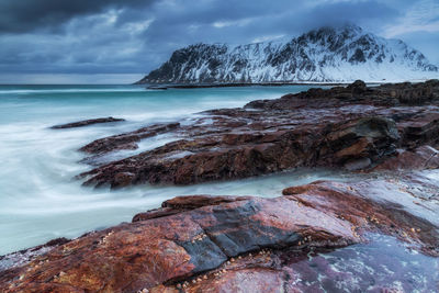 Rocks on beach against sky