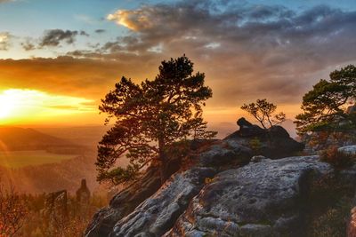 Scenic view of rock against sky during sunset