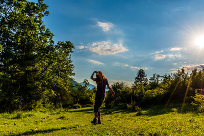 Full length of man standing on field against sky
