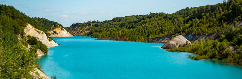 Scenic view of swimming pool by sea against sky