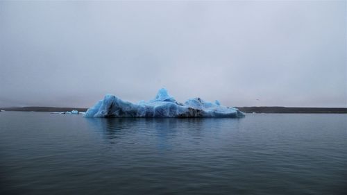 Scenic view of frozen lake against sky