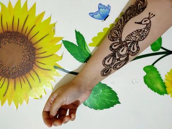 High angle view of woman holding leaves on table