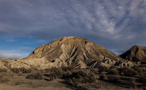 Landscape of tabernas desert, almeria, spain, against cloudy sky