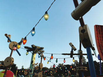 Low angle view of lanterns hanging against sky