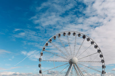 Low angle view of ferris wheel against sky