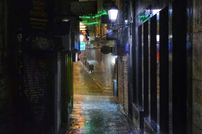 Illuminated underground walkway at night