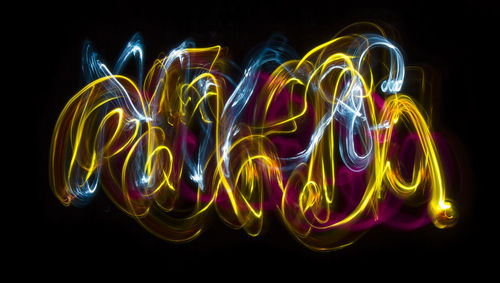 Close-up of illuminated lights over black background