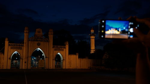 Illuminated building against sky at night