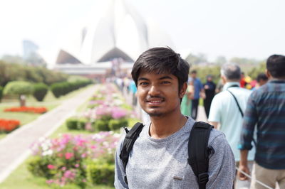 Portrait of young man standing at park