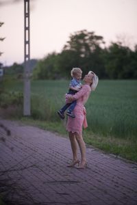 Rear view of woman standing on field