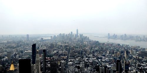 Aerial view of modern buildings in city against sky