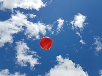 Low angle view of balloons against sky