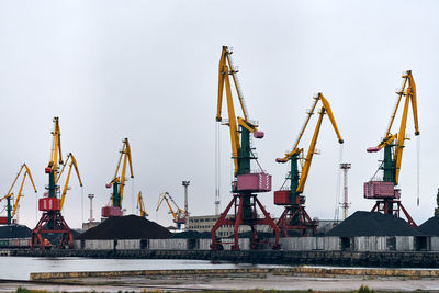 Massive harbor cranes in seaport. heavy load dockside cranes in port, cargo container yard