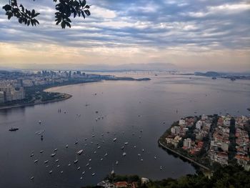 High angle view of river by buildings against sky