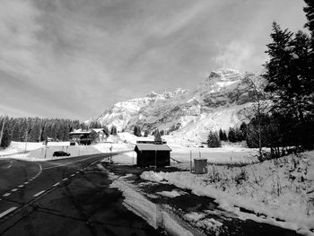 Scenic view of snow covered mountains against sky