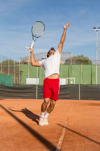 Full length of man playing tennis