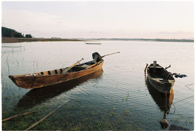 Boat moored in sea against sky