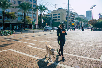 Man with dog on street in city