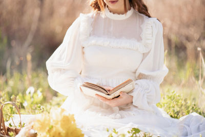 Young woman sitting on field