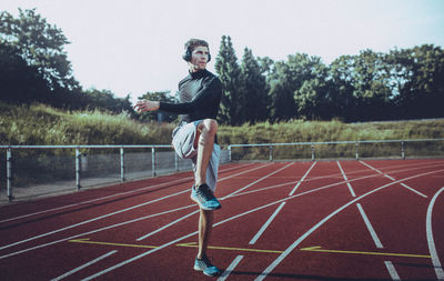 Young man exercising on running track