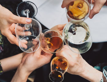 Midsection of people holding drink