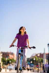 Young woman riding bicycle