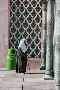 Rear view of woman against building