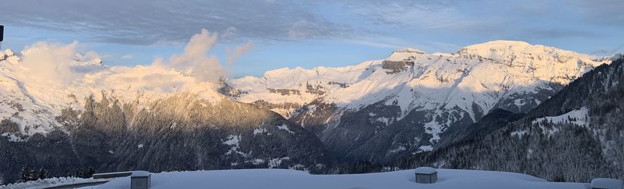 Panoramic view of snowcapped mountains against sky