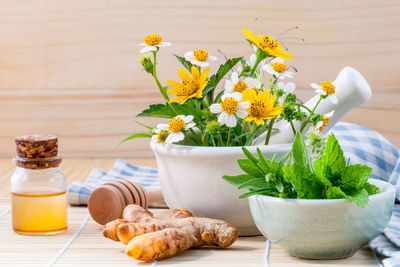 Close-up of mortar and pestle with herbs table