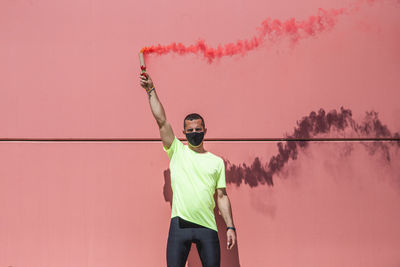 Runner holds a red smoke grenade