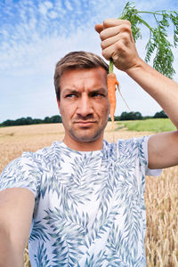 Portrait of young man holding camera