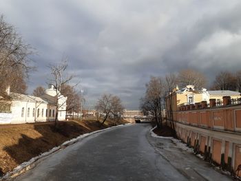 Empty road along trees in winter