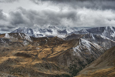 Scenic view of mountains against cloudy sky