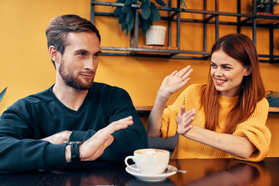 Cheerful couple sitting at restaurant