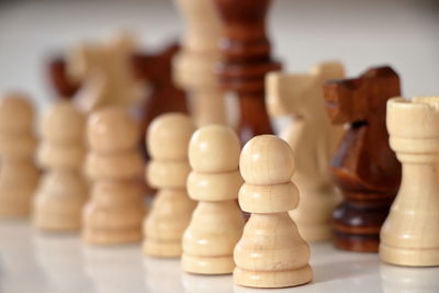 Close-up of wooden chess pieces on table