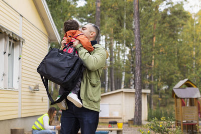 Father collecting son from school