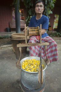 Midsection of person boiling silk cocoons in container