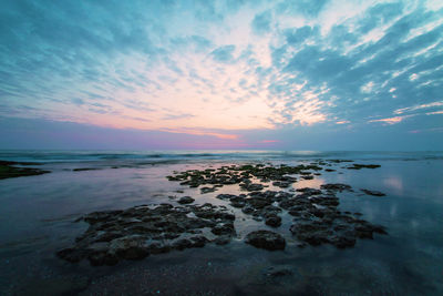 Scenic view of sea against sky at sunset