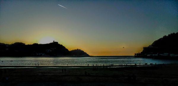 Scenic view of sea against clear sky during sunset