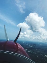 Close-up of airplane wing against sky