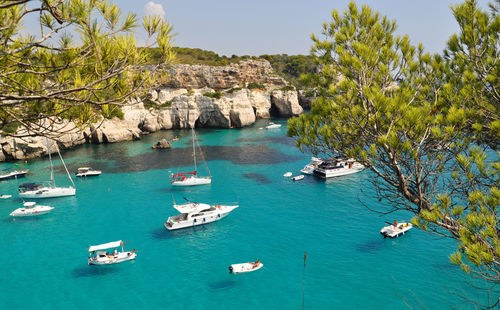 High angle view of boats sailing in sea against clear sky