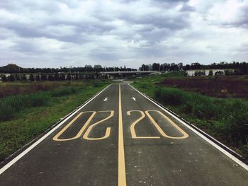 High angle view of number on road by field