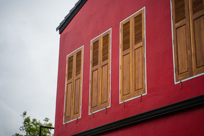 Low angle view of red building against sky