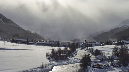 Scenic view of snow covered mountains against sky